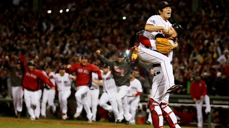 Koji Uehara #19 of the Boston Red Sox celebrates with David Ross