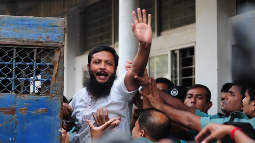 One of the accused soldiers gestures following the announcement of his death penalty at the special court in Dhaka