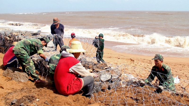 Vietnamese prepare for onslaught of deadly typhoon building dikes around the coastline