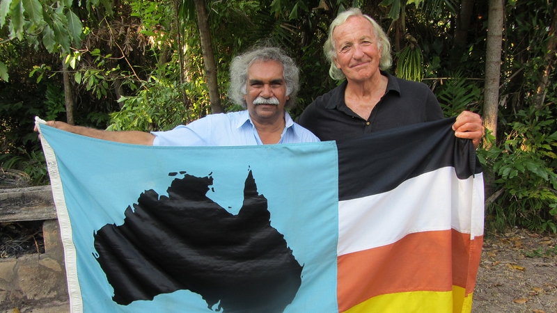 Flagging the awful truth about the plight of Aborigines today - John Pilger and friend