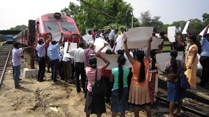 Pro-government activists block a train carrying Britain's Channel 4 television crew who made an award-winning documentary on alleged warcrimes in Sri Lanka