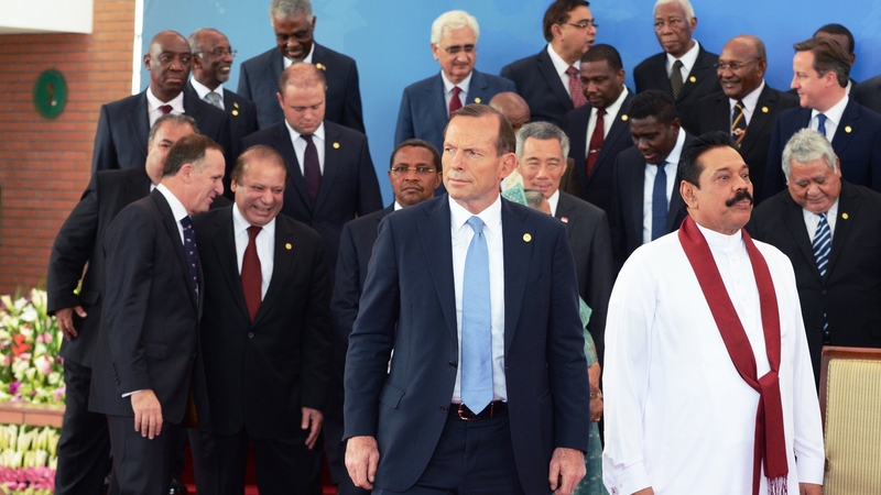 Prime Minister of Australia Tony Abbott (C) and Sri Lankan President Mahinda Rajapaksa (R) lead other heads of state from the Commonwealth after posing for an official portrait photograph
