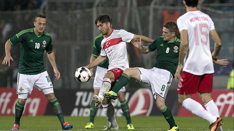 Adem Buyuk and Steven Davis vie for posession