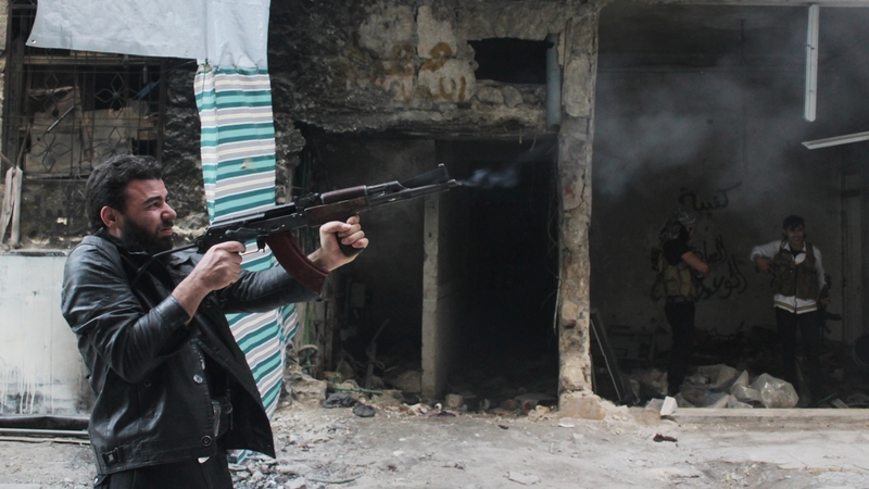 A rebel fighter from the Free Syrian Army fires his weapon during fighting against government forces in the Salah al-Din neighbourhood of the northern Syrian city of Aleppo