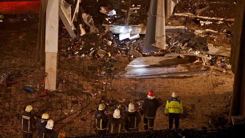 Rescuers at the ruins of the Maxima supermarket in Riga where at least 54 died after the roof collapsed