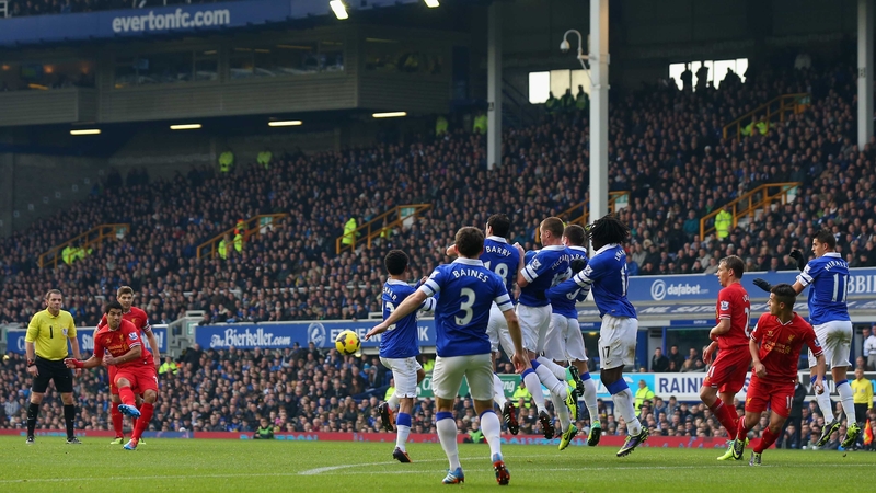 Luis Suarez scores a free kick against Everton