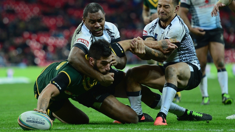 Darius Boyd of Australia scores a try through the tackle of Aaron Groom and Apisai Koroisau of Fiji