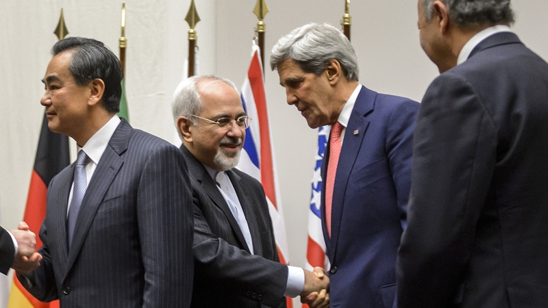 Iranian foreign minister Mohammad Javad Zarif shakes hands in Geneva with US Secretary of State John Kerry after the agreement
