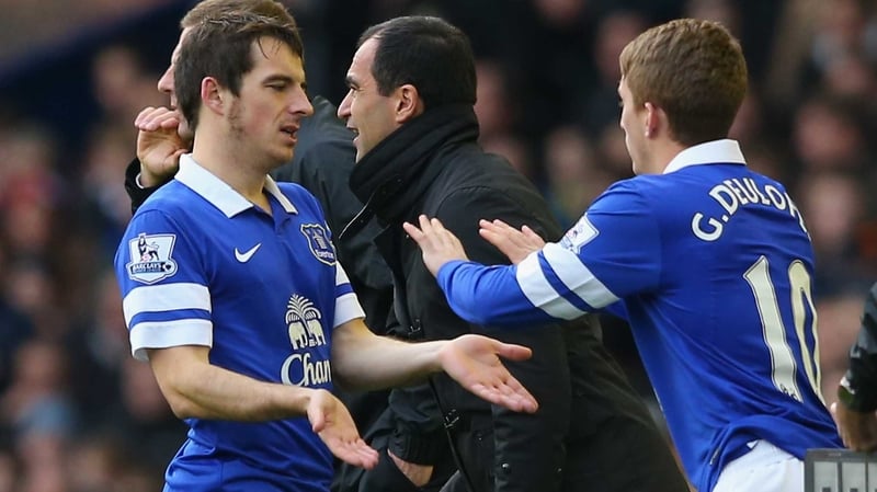 Baines (l) was forced off early in the second half against Liverpool