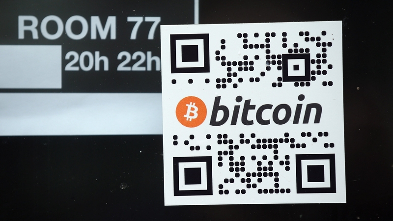 A sticker on the window of a local pub indicates the acceptance of Bitcoins for payment in Berlin, Germany