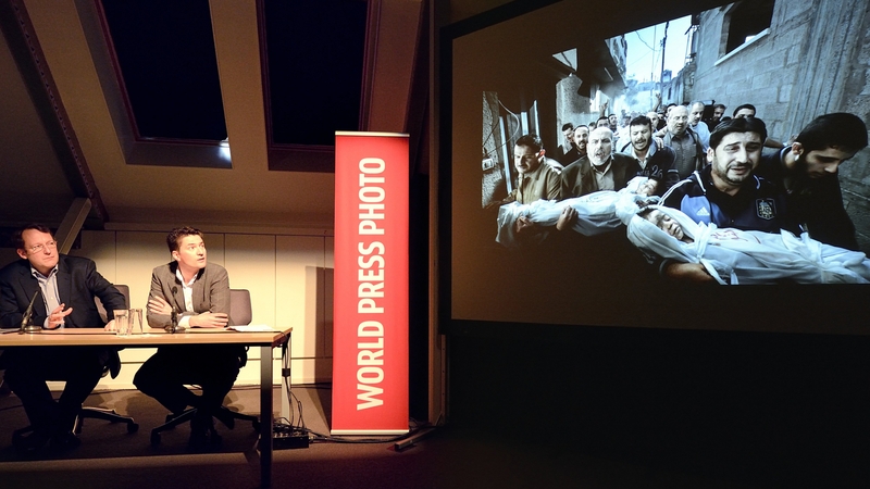 Jury president Santiago Lyon and Managing Director of World Press Photo Michael Munneke look at the contest's winning photo