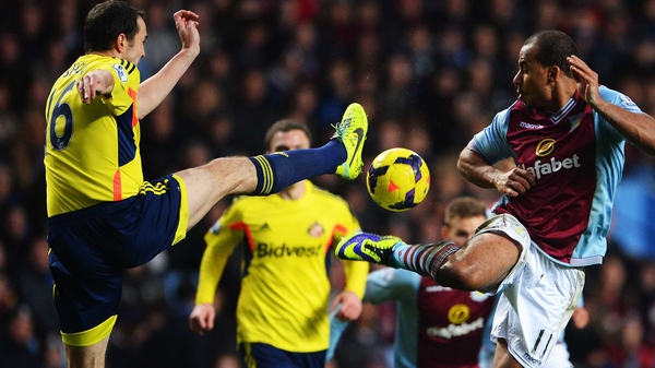 John O'Shea of Sunderland tackles Aston Villa's Gabriel Agbonlahor