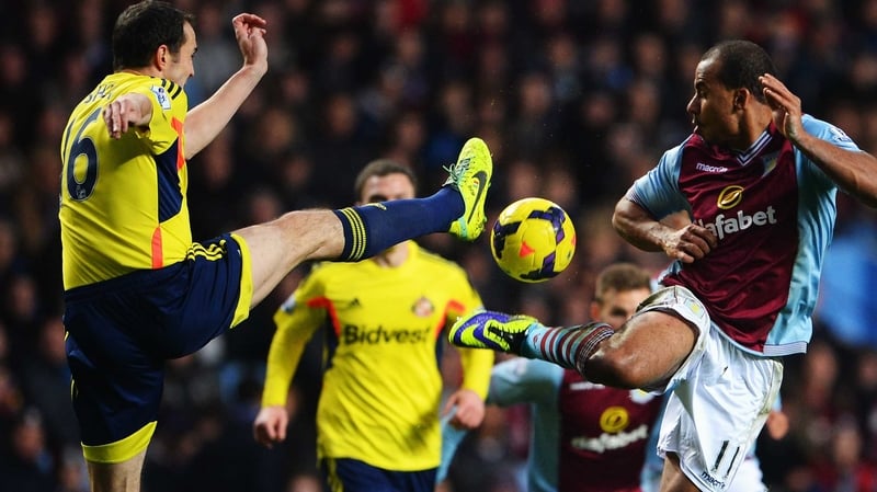 John O'Shea of Sunderland tackles Aston Villa's Gabriel Agbonlahor