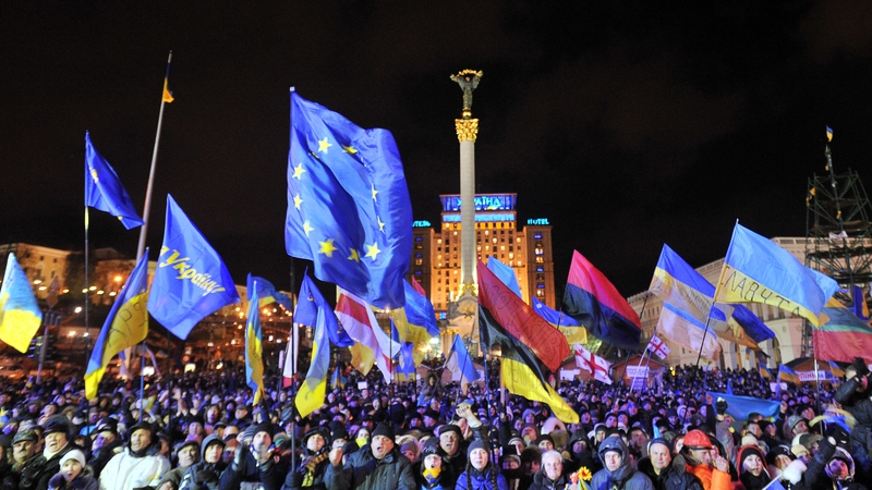 People shout slogans and wave Ukrainian and European Union flags during an opposition rally at Independence Square in Kiev