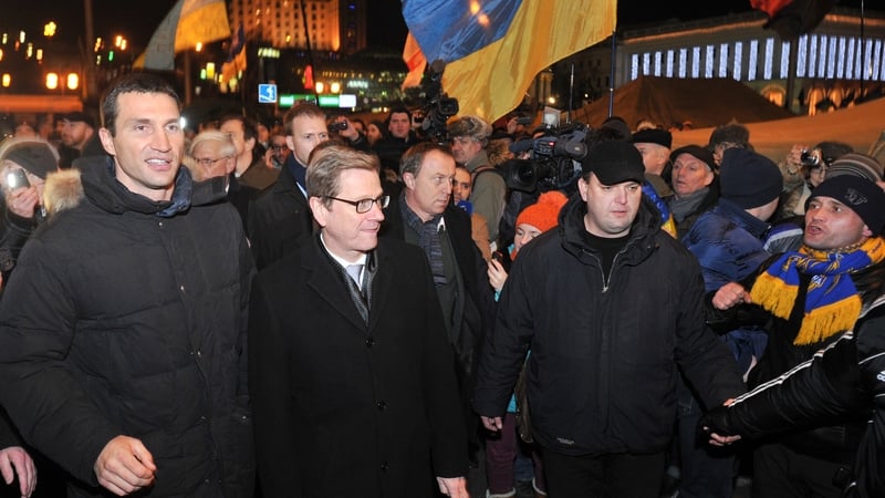 German Foreign Minister Guido Westerwelle (centre) visits anti-government protests in Kiev with Ukrainian boxing champion Wladimir Klitschko (L)