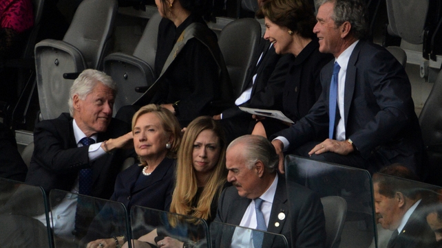 Former US presidents Bill Clinton and George Bush chat at the service - also pictured are Laura Bush, Hillary Clinton and Chelsea Clinton