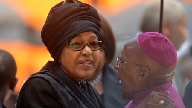 Winnie Mandela and Archbishop Emeritus Desmond Tutu greet each other