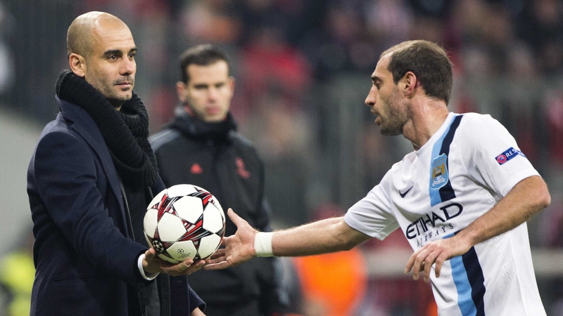 Pep Guardiola hands the ball to Manchester City's Pablo Zabaleta during Bayern Munich's clash with Manchester City in 2013