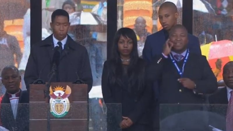 The hunt is on for the mystery 'signer' (right wearing security pass)