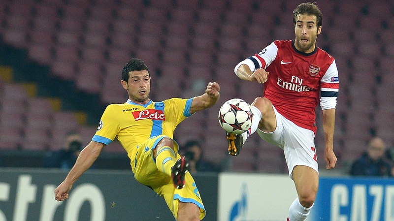 Arsenal's Mathieu Flamini beats Napoli's Blerim Dzemaili to the ball