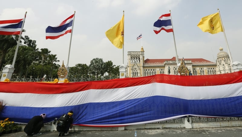 Thai protesters have wrapped Bangkok's Government House with a massive national flag