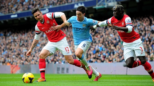 Bacary Sagna (right) will swap the red of Arsenal for the sky blue of Man City next season