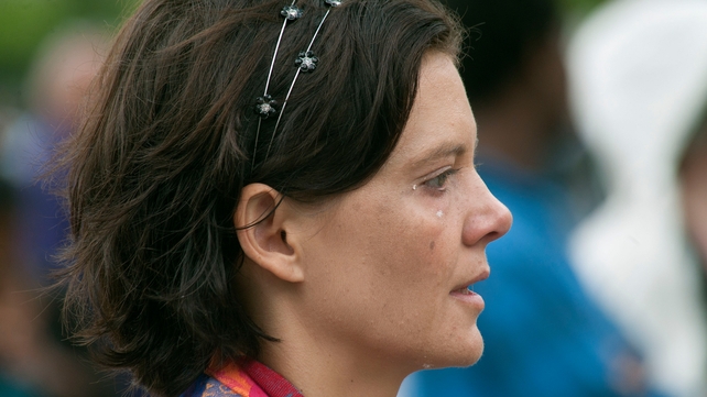 A woman cries as she watches the ceremony on a screen at the City Hall in Cape Town