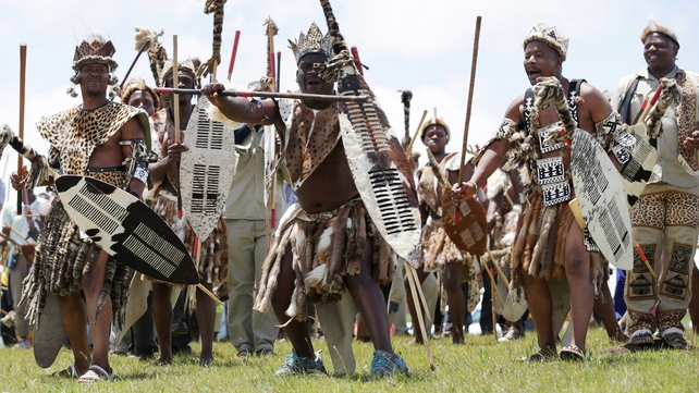 Zulu men perform a traditional dance in the hills above Qunu during the funeral ceremony