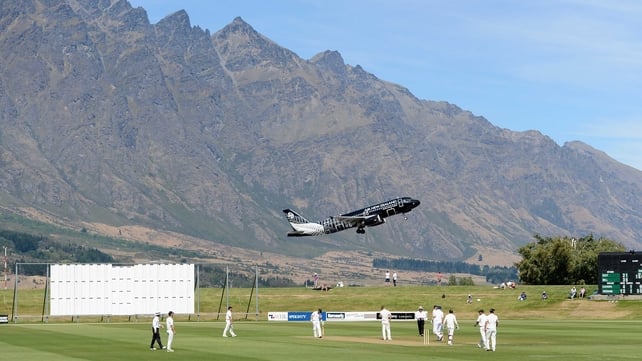 An aeroplane takes off as England's cricketers take on a New Zealand XI in the Remarkables mountain range in Queenstown
