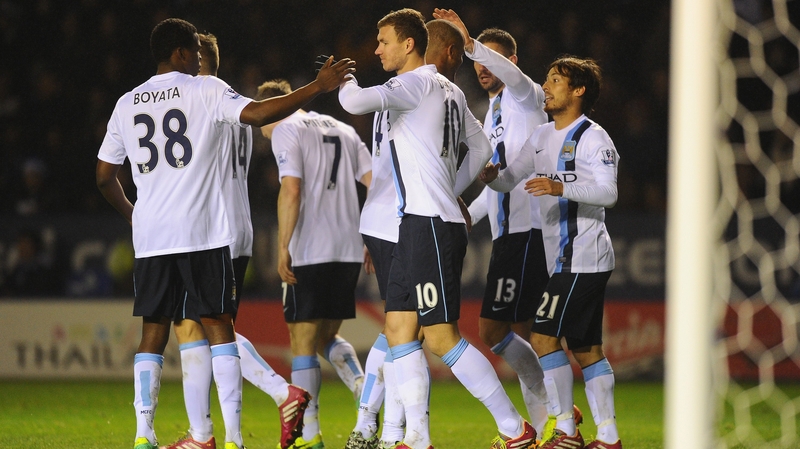 Edin Dzeko celebrates scoring City's third goal against Leicester