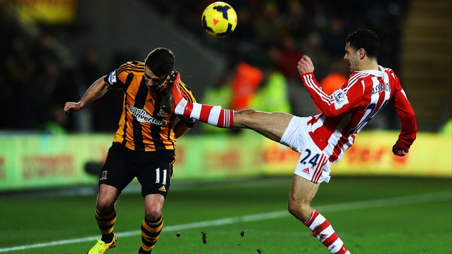 Oussama Assaidi of Stoke puts in a high challenge on Hull's Robbie Brady at the KC Stadium