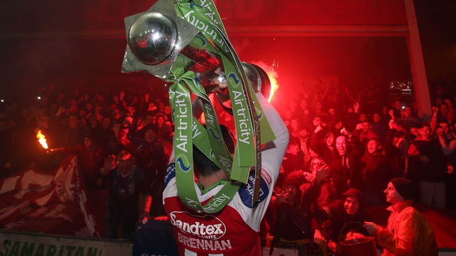 Killian Brennan of St Patrick's Athletic lifts the Airtricity League Premier Division trophy in front the of the Inchicore faithful