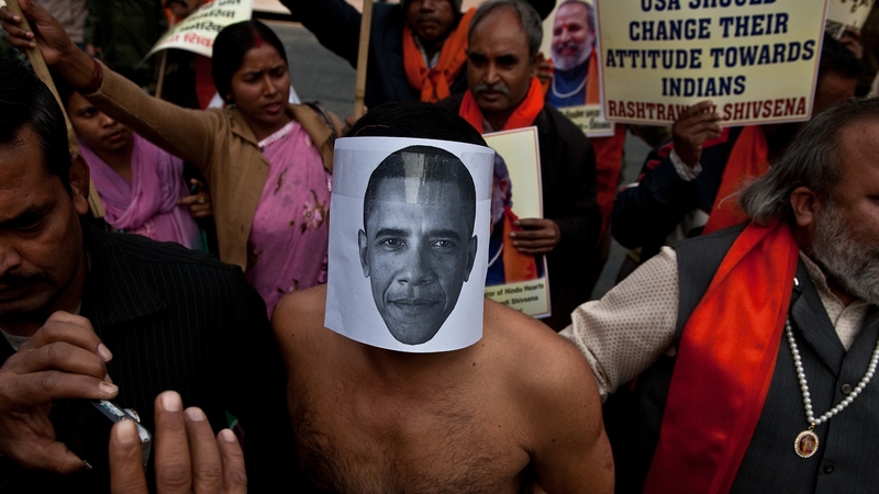 An activist wearing a mask depicting US President Barack Obama takes part in a protest near the US Embassy in New Delhi