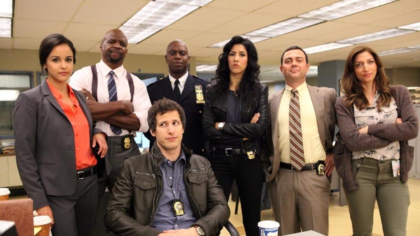Andy Samberg (seated) stars as an infantile cop in new US comedy Brooklyn Nine-Nine