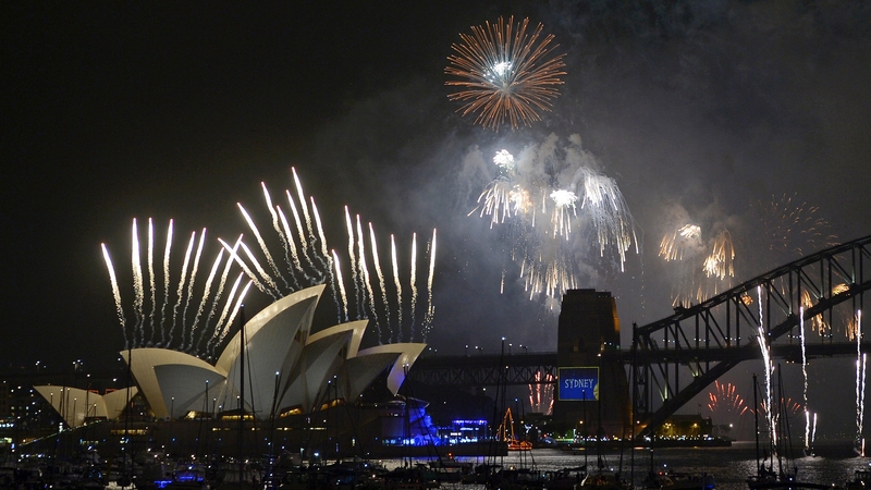 New Year's Eve fireworks erupt over Sydney's iconic Harbour Bridge and the Opera House