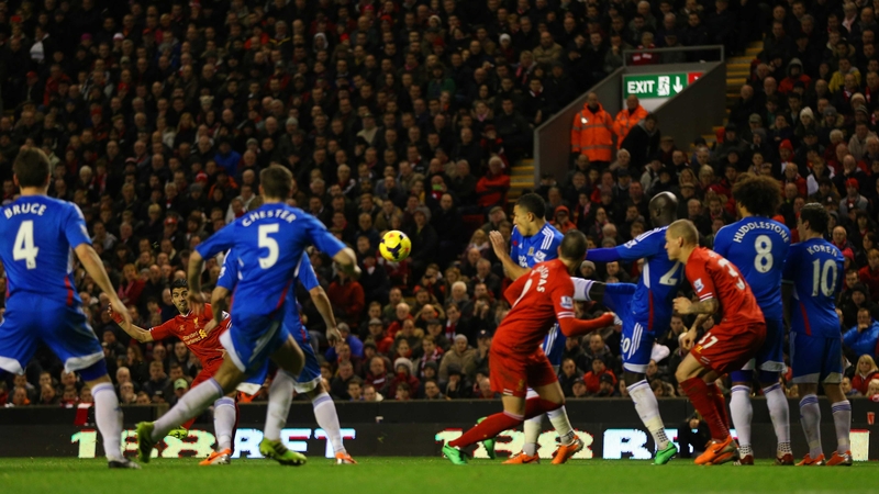 Luis Suarez scores from a free kick