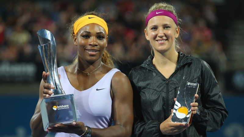 Serena Williams (L) poses with the winners trophy and Victoria Azarenka poses with the runner up trophy