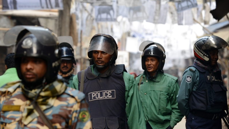 Bangladeshi riot police patrol a neighbourhood where several local polling stations are located in Dhaka