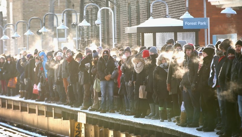 Passengers heading into downtown Chicago wait in sub-zero temperatures for the train to arrive