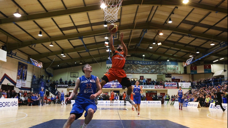 Isaac Westbrooks climbs high, watched by Colin O'Reilly