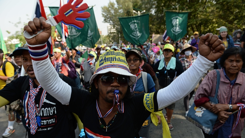 Thai anti-government protesters marching through the streets of Bangkok on Thursday