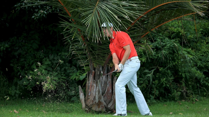 Tommy Fleetwood plays his second shot on the par five, 14th hole