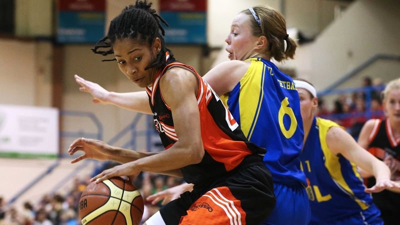 Candace Bond shields the ball from Huskies' Rachel Clancy