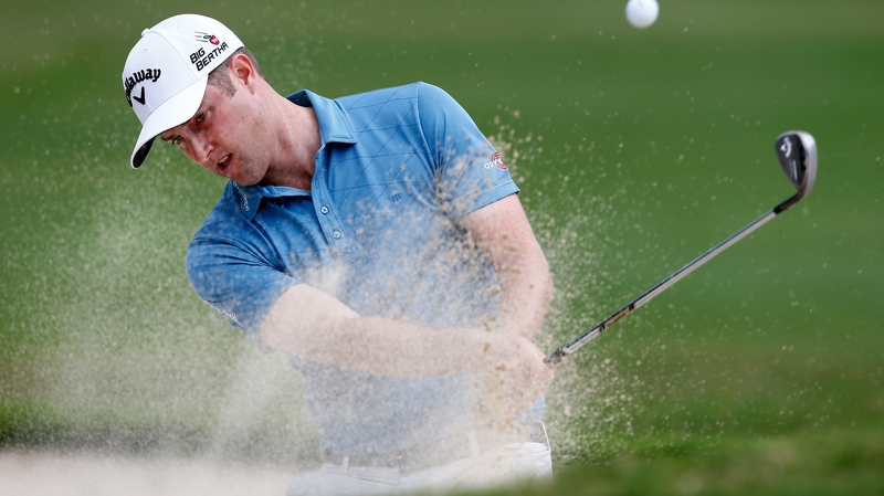 Leader Chris Kirk Chris hits out of a bunker on the 18th hole