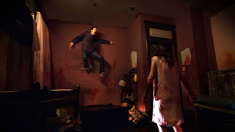 Zach gets pinned against the wall by his wife Samantha (serves him right, all that bloody filming)