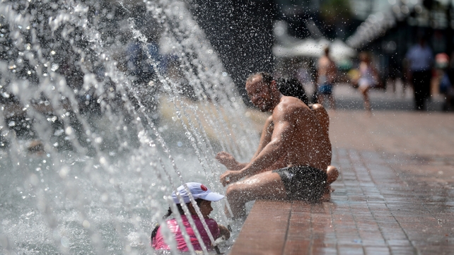 People cool off in a fountain at Darling Harbour as temperatures soared to 41.8C Celsius in Sydney last week