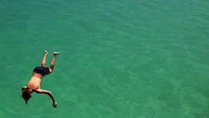 A man jumps from the jetty during the heat wave in Adelaide, Australia