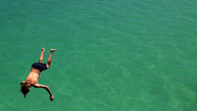 A man jumps from the jetty during the heat wave in Adelaide, Australia