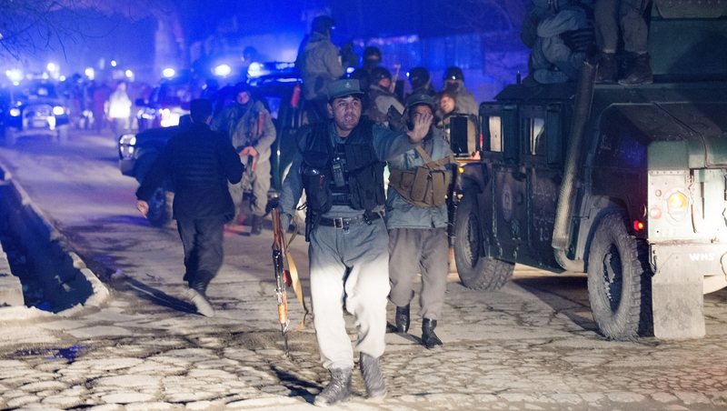 Afghan police stand guard at scene of the fatal attack in the Wazir Akbar Khan neighbourhood