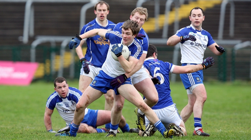 Monaghan's Jack McCarron battles with ball-holder James McEnroe of Cavan